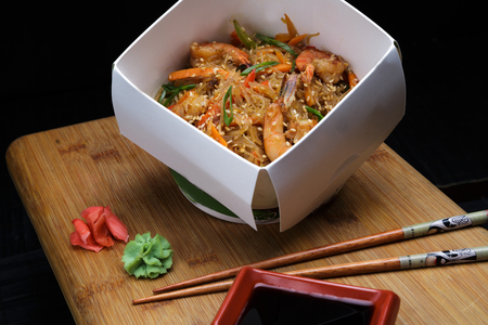 Chinese Noodle with shrimps and vegetables in box to take away. Delicious chinese fast food with healthy ingredients. Organic meal for gourmand.の写真素材