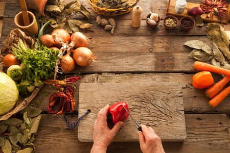 Red bell pepper prepared for cooking vegetarian meal. Ingredients for cooking healthy nutrition food.の写真素材