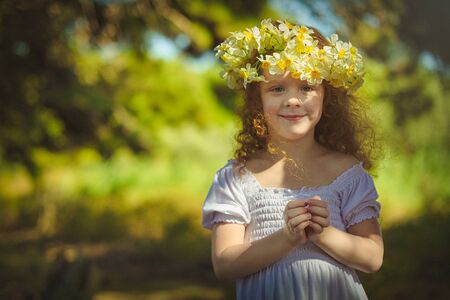 Red hair girl walking into woods with flowers.の写真素材
