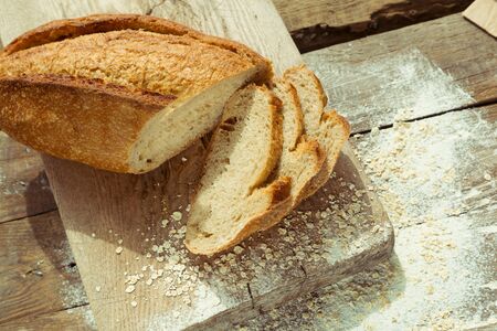 Sliced gluten free bread on wooden table. Healthy lifestyle with homemade organic bread.