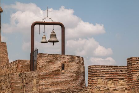 Church bell on tower with blue sky.
