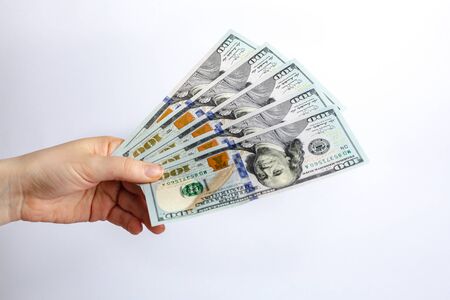 Hundred dollars banknote in hand, cash money to spend right now. Economic crisis as a consequences...