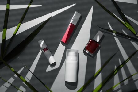 Decorative makeup cosmetic products for summertime, advice from blogger which brand to use. Orange background composition with lipstick and brush.の写真素材