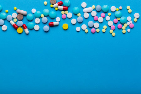 A lot of multi-colored pills on blueの写真素材