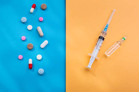 A lot of pills and syringe with injection as a symbol of choice antibiotics  vaccine from   Insulin...