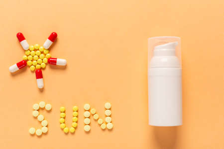 Protective face cream from UV with colorful pills in the shape of the sun. Spf protection in summer...
