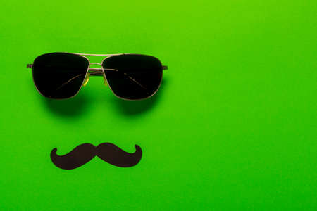 Glasses and mustache as a symbol of fathers day with free space for text, greeting card for holiday.の写真素材