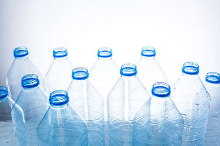 Plastic bottles on a blue background as a symbol of ecological catastrophes.の写真素材