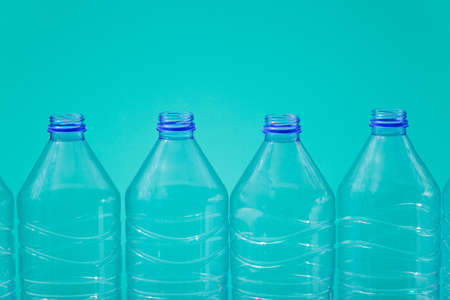 Plastic bottles on a blue background as a symbol of ecological catastrophes.