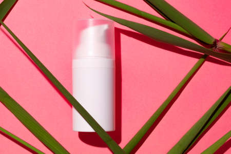 White skincare product tube on a pink background, advertisement concept. Body skin treatment container with a place for brand, free space for text.の写真素材
