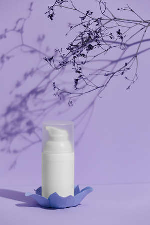 White skincare product tube on a purple background, advertisement concept. Body skin treatment...