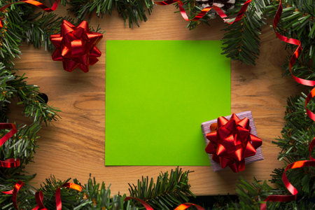 Wooden background with Christmas decorations and free space for greetings or a list of guests. New...
