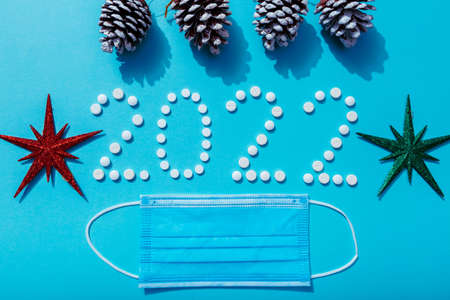 2022 new year written with white pills and new year decorations, the concept of medical treatment....