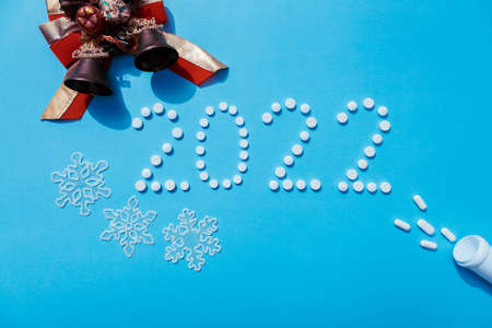 2022 new year written with white pills and new year decorations, the concept of medical treatment.の写真素材