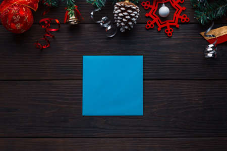 Wooden background with Christmas decorations and free space for greetings or a list of guests. New year concept empty board.の写真素材