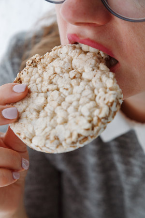 Close-up of woman mouth eating dietical crispbread.の写真素材