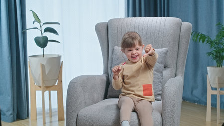 Cute laughing toddler girl liking lollipop