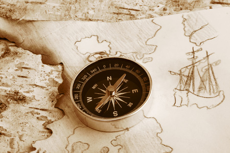 Old dingy chart of North Europe and compass