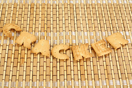 Word cracker laid out from cookies on a bamboo napkinの写真素材