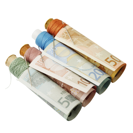 Abstract concept. Renovation of European financial system. Colored threads and needles in Euro on white background. Clipping pathの写真素材