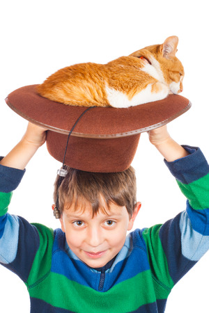 Boy and his lazy red cat in hat. Isolated on whiteの写真素材