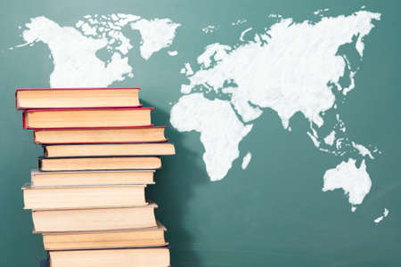 Books and chalk drawing of World mapの写真素材