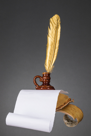 Education and literature concept. Abstract wood desktop with paper and gold quill pen of a writer, poet, teacher, professorの写真素材
