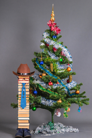Children's school New Year's idea with unusual teacher and Christmas treeの写真素材