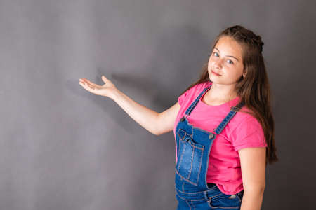 The girl talks over the task and gesticulates with handの写真素材