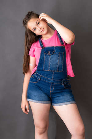 Happy young beautiful caucasian girl posing and looking to the cameraの写真素材