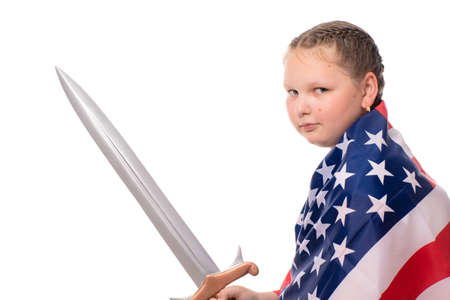A small strong girl with an American flag and a sword. Isolation on whiteの写真素材