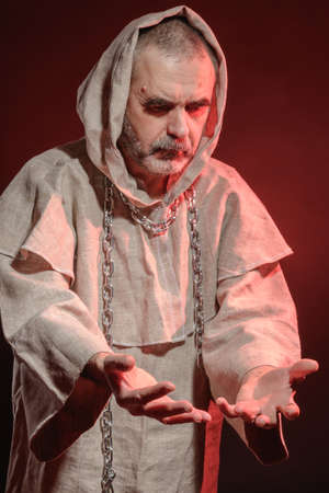 A monk in a red glow ponders the fleetingness of life
