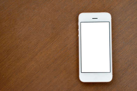 Smartphone mock-up on wood tableの写真素材