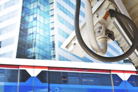 Traffic surveillance camera with skytrain in the backgroundの写真素材