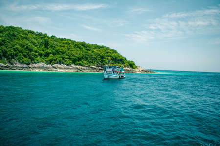 Beautiful view blue see, rough waves, and skyline with scuba diver floating on the sea in evening at Samaesarn Island, Chonburi Thailand.の写真素材