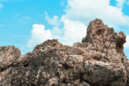 Low angle view of stone in foreground and beautiful blue sky in the background.