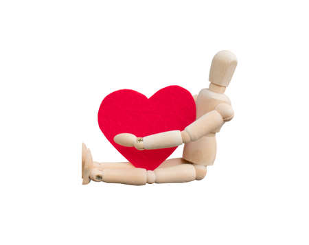 Wooden dummy hug a heart shape that made from acrylic felt fabric. Valentine's day conceptの写真素材