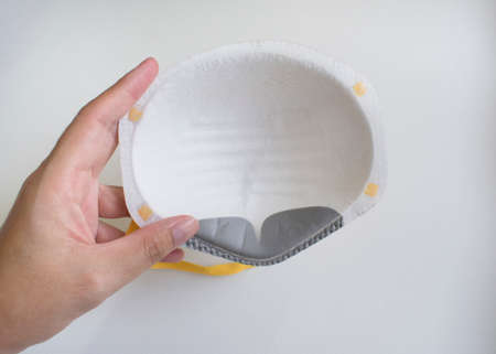 Hand hold the N95 mask particulate filter show insideの写真素材