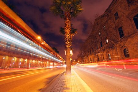 rush of night time traffic on roadin  barcelona, spainの写真素材