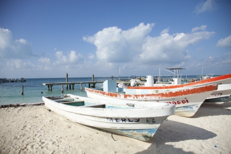 fishing boats on the beach in isla mujeres mexico. beautiful colours.のeditorial素材