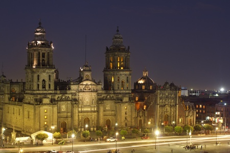 the zocalo in mexico city at night, with the cathedral and giant flag in the centreのeditorial素材