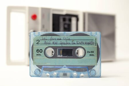 an old audio cassette in front of a retro tape player
