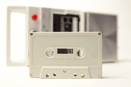 an old audio cassette in front of a retro tape player