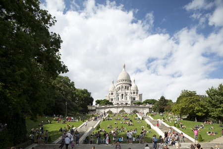 a view of sacre coeur with tourists on the stepsのeditorial素材