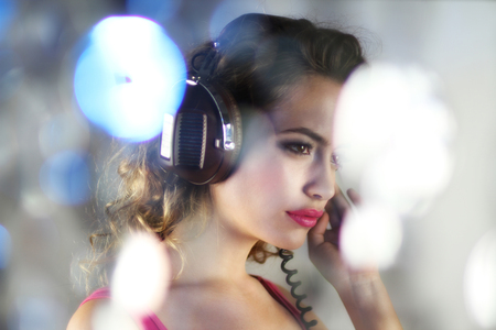 head shot of beautiful dancing woman listening to music on headphonesの写真素材