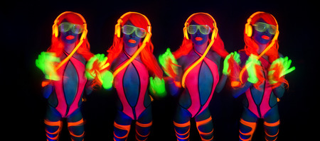 sexy female disco dancer poses in UV costumeの写真素材