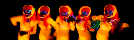 sexy female disco dancer poses in UV costume