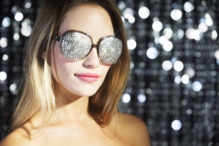 close up of stunning sexy disco woman with crystal covered sunglassesの写真素材