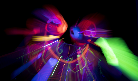 2 sexy cyber glow raver women filmed in fluorescent clothing under UV black light