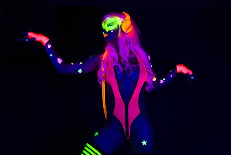 sexy female disco dancer poses in UV costumeの写真素材